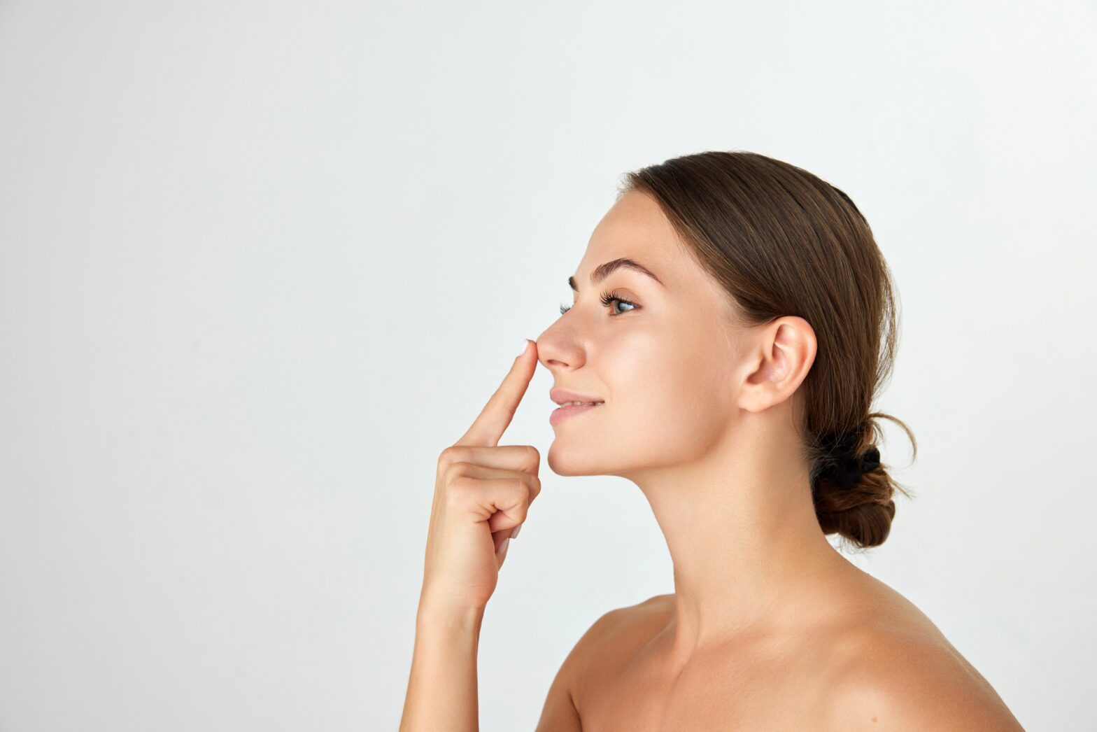 Side view of woman touching her nose